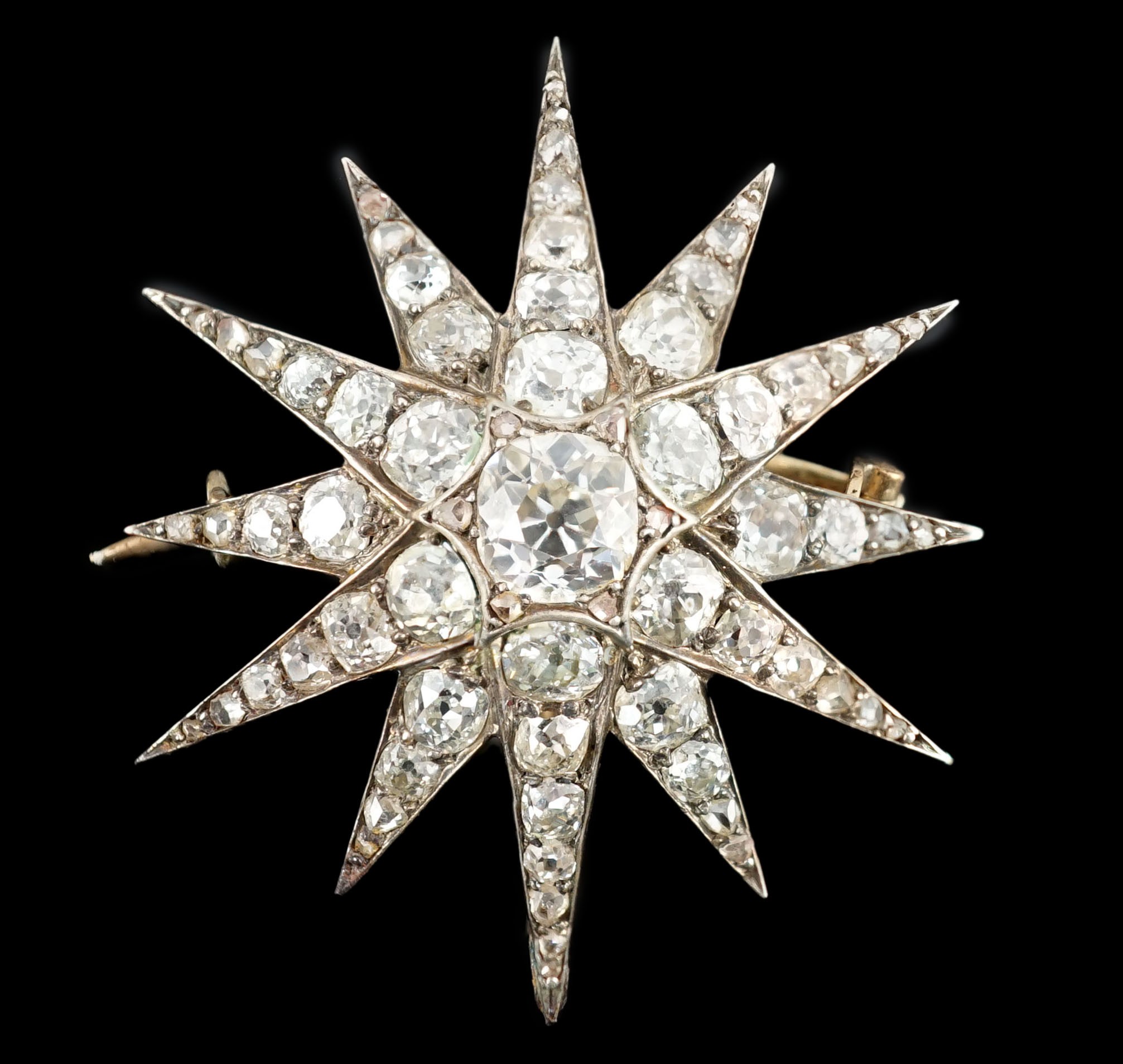 A Victorian gold, silver and graduated old cut diamond set starburst brooch